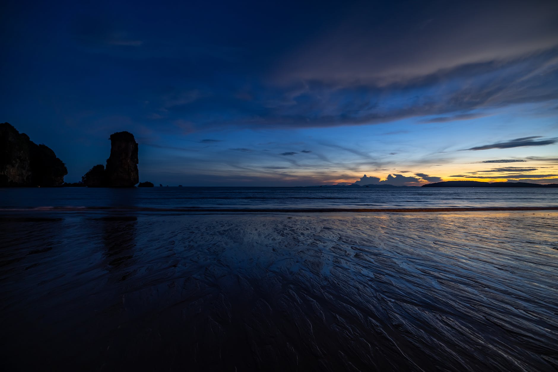 silhouetted rock formation on the beach in phuket thailand
