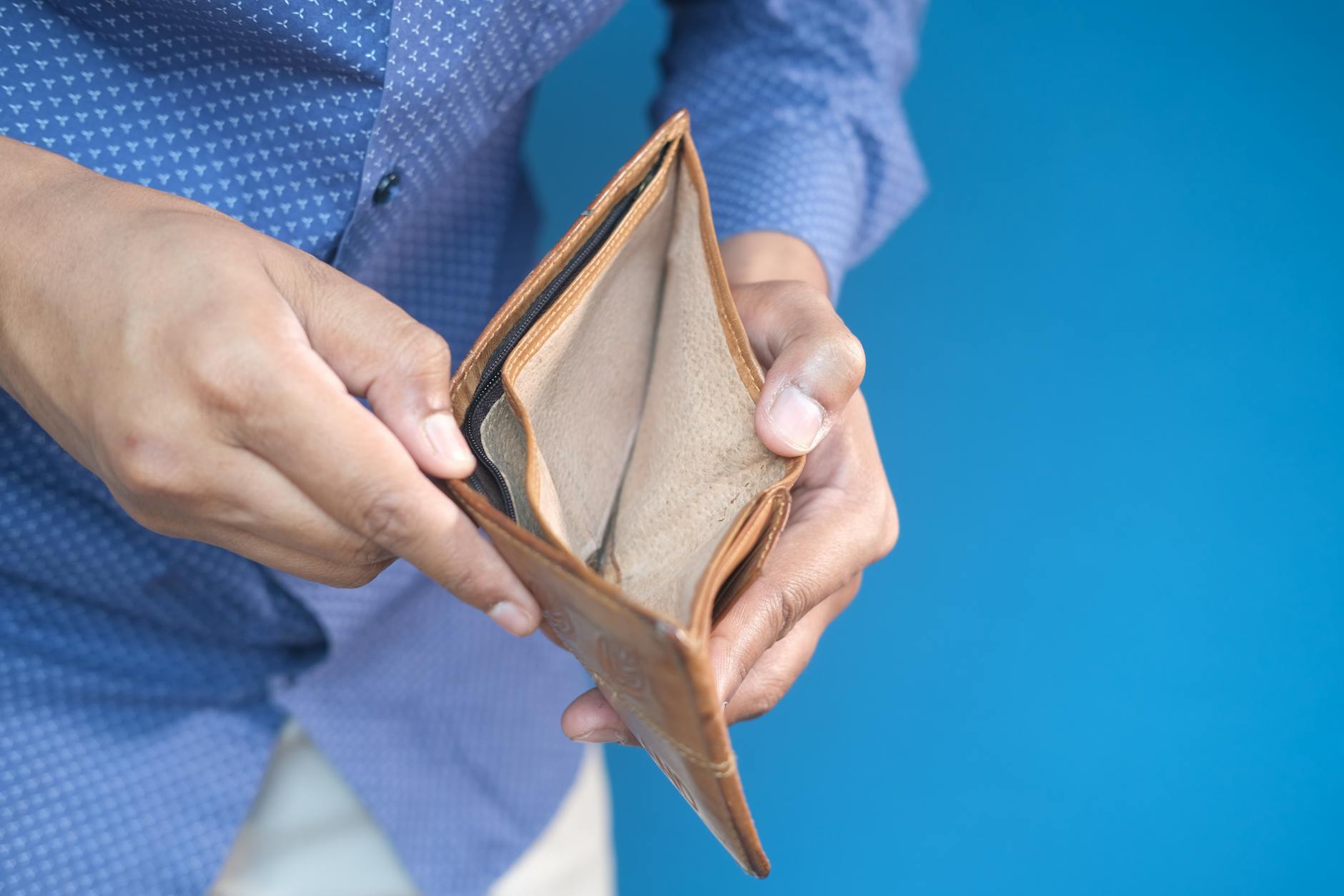 a person holding an empty wallet
